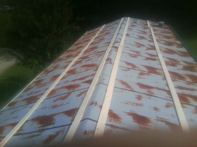 Rusted metal roof panels with new wood purlins before replacement — Storm Damage Roof Repair in Kokomo by Roofing Brothers